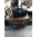 A vintage leather gladstone bag, along with three vintage trunks