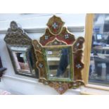 A decorative Persian style gilt framed mirror with hand painted glass sections