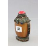 19th Century Tibetan snuff bottle, the ovoid agate body within a metal framework a coral stopper