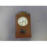 A 1920's oak cased mantel clock with brass bell