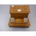 An early 20th century oak stationary unti, with single drawer and original glass inkwells