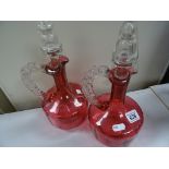 Pair of cranberry glass decanters with stoppers