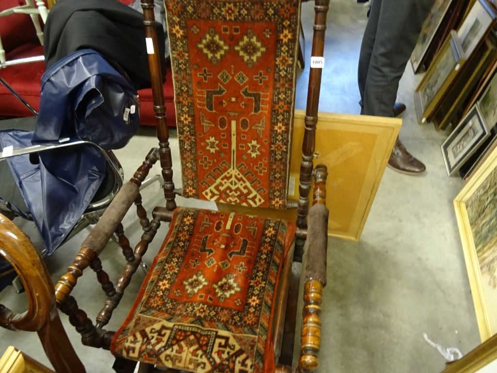 An American fruitwood rocking chair, with Persian upholstery