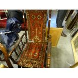 An American fruitwood rocking chair, with Persian upholstery