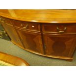 Regency style bow fronted sideboard with a cluster of 3 short drawers above 3 cupboards