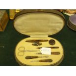 Ladies oval shaped case containing a tortoise shell manicure set, and 1 other part complete manicure