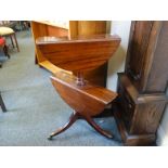 Regency mahogany two tier dumb waiter C1810. Each section with collapsible sides on brass castors