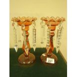 Pair of cranberry glass luster’s each one with 5 glass drops 10" tall approx with gilt boarders