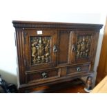 18c style oak cabinet 3' tall with 2 carved door panels to front above 2 short drawers