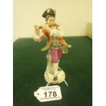 19th early 20 th Century Meissen, a man playing a flute in a red coat, blue crossed sword