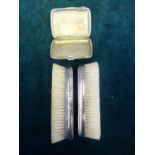 Silver cigarette case, pair of silver bound clothes brushes,