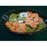 Vintage green glazed William Moorcroft trinket dish, the exterior decorated with tube lined flowers,