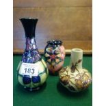 Small Moorcroft contemporary bud vase, details and makers mark to base on a blue and green ground