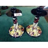 Good quality pair of Moorcroft candlesticks, hand painted with tube line decoration, pattern Pansy