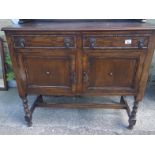 Oak 1930's dresser, plate rack to the back above a base unit containing 2 doors and 2 drawers