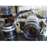 Nikon, a FM2 35mm camera with instructions, a collection of 4 x Nikon lenses and a collection of