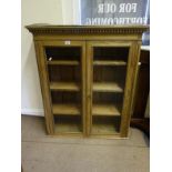 Stripped pine show cabinet with 2 x glazed doors to the front, shelving enclosed