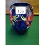 Large blue and white William Moorcroft vase, tube line decoration of flowers to the boarder, 7"