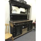 Jacobean large dresser, profusely carved throughout with large rectangular mirrored back and a shelf