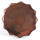 Eustace Bros. Copper Tray of circular scalloped form decorated a border of flowers on a hammered