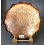 Eustace Bros. Copper Tray of circular scalloped form decorated a border of flowers on a hammered