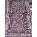 An antique red ground rug with 5 medallions 9'6” x 4'6”