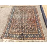 An antique blue ground rug with all over design 6'3” x 5'4”