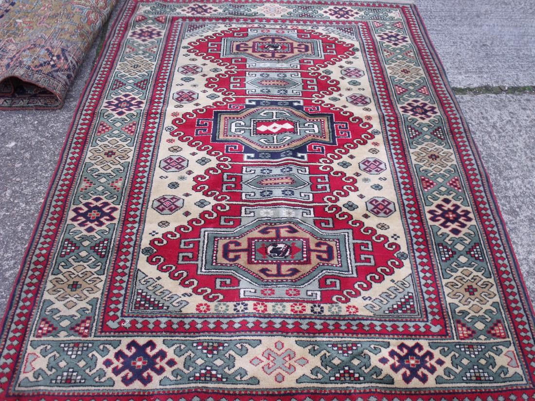 Good condition red ground rug with 5 medallions 7'6” x 5'