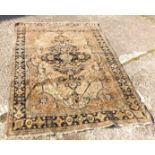 An antique blue ground rug with medallion to centre 6' x 5'4”