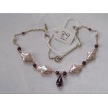 A garnet and baroque pearl necklace