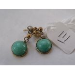 A pair green stone gold mounted earrings