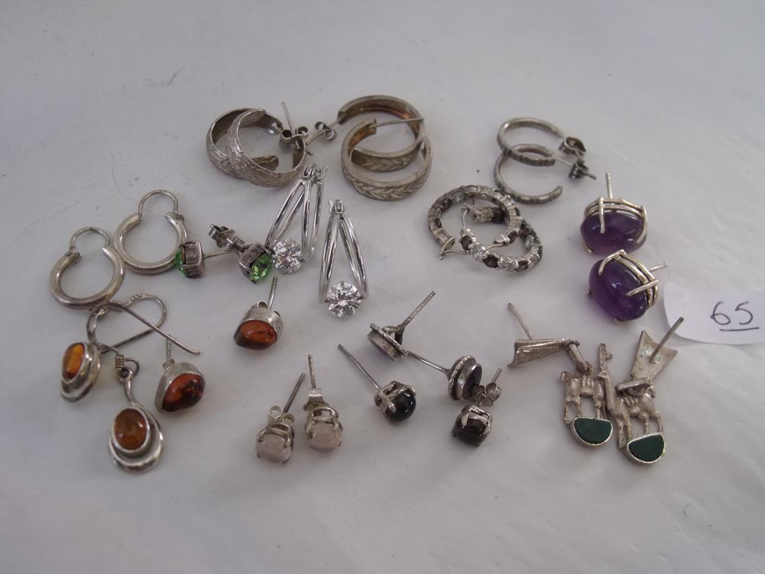 Fourteen pairs of silver earrings