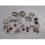 Fourteen pairs of silver earrings