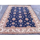 A small blue ground carpet with hanging lamps 10'4” x 6'9”