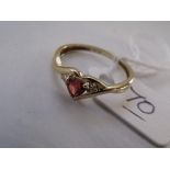 A garnet set three stone ring