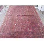 An antique red ground rug 8'6” x 5'4”