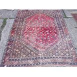Red ground rug with large medallion 6'4” x 4'10”