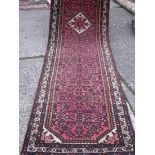Red ground runner with ivory centre medallion 12'6” x 2'9”