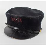 A Royal Hospital pensioner's uniform shako. A black cloth shako embroidered RH" to the front in