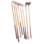 Golf a collection of eight hickory shafted golf clubs. Includes two woods, five irons and a putter.