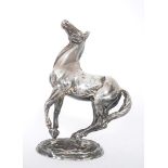 A silver figure of a horse by Lorne McKean. The horse taking flight, on an oval naturalistic base