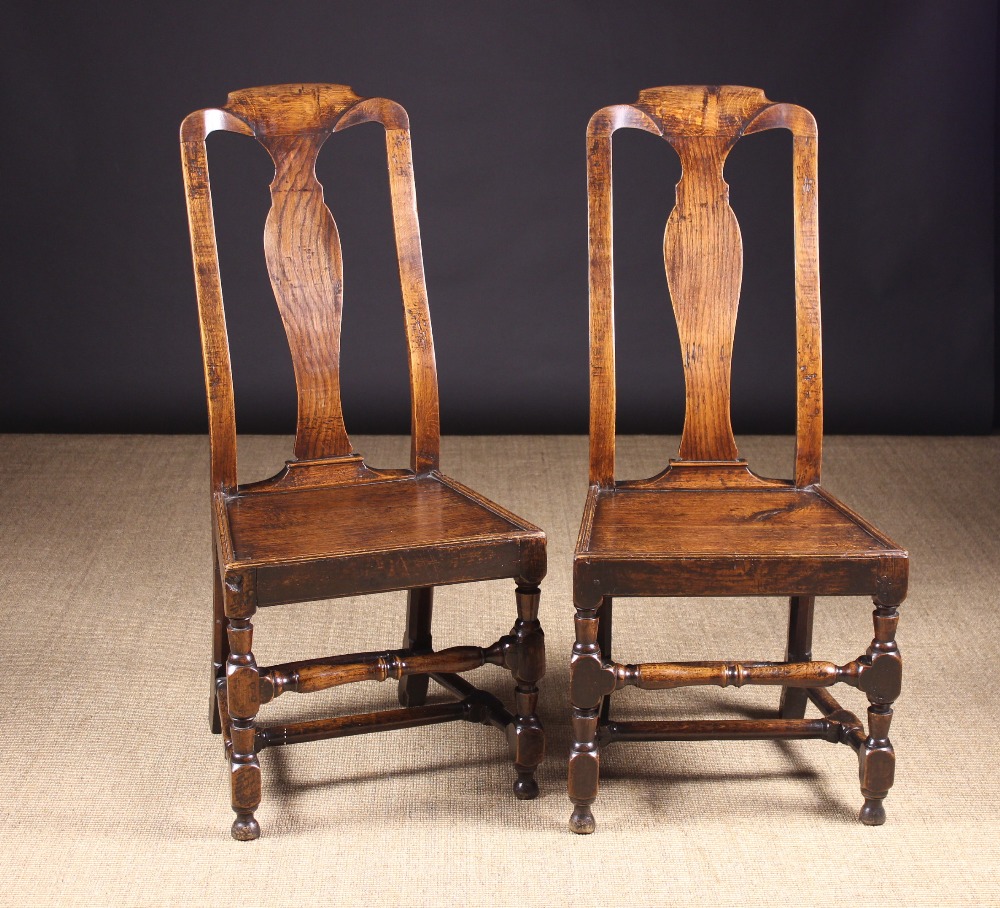 A Pair of 18th Century Joined Oak Side Chairs. The high backs having a shaped centre splat.