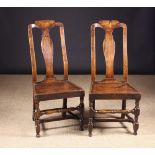 A Pair of 18th Century Joined Oak Side Chairs. The high backs having a shaped centre splat.