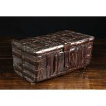 A 15th/16th Century Cuir Bouilli Casket of rectangular form, bound in studded iron straps,