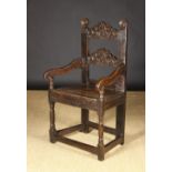 A 17th Century Derbyshire/South Yorkshire Style Carved Oak Armchair.