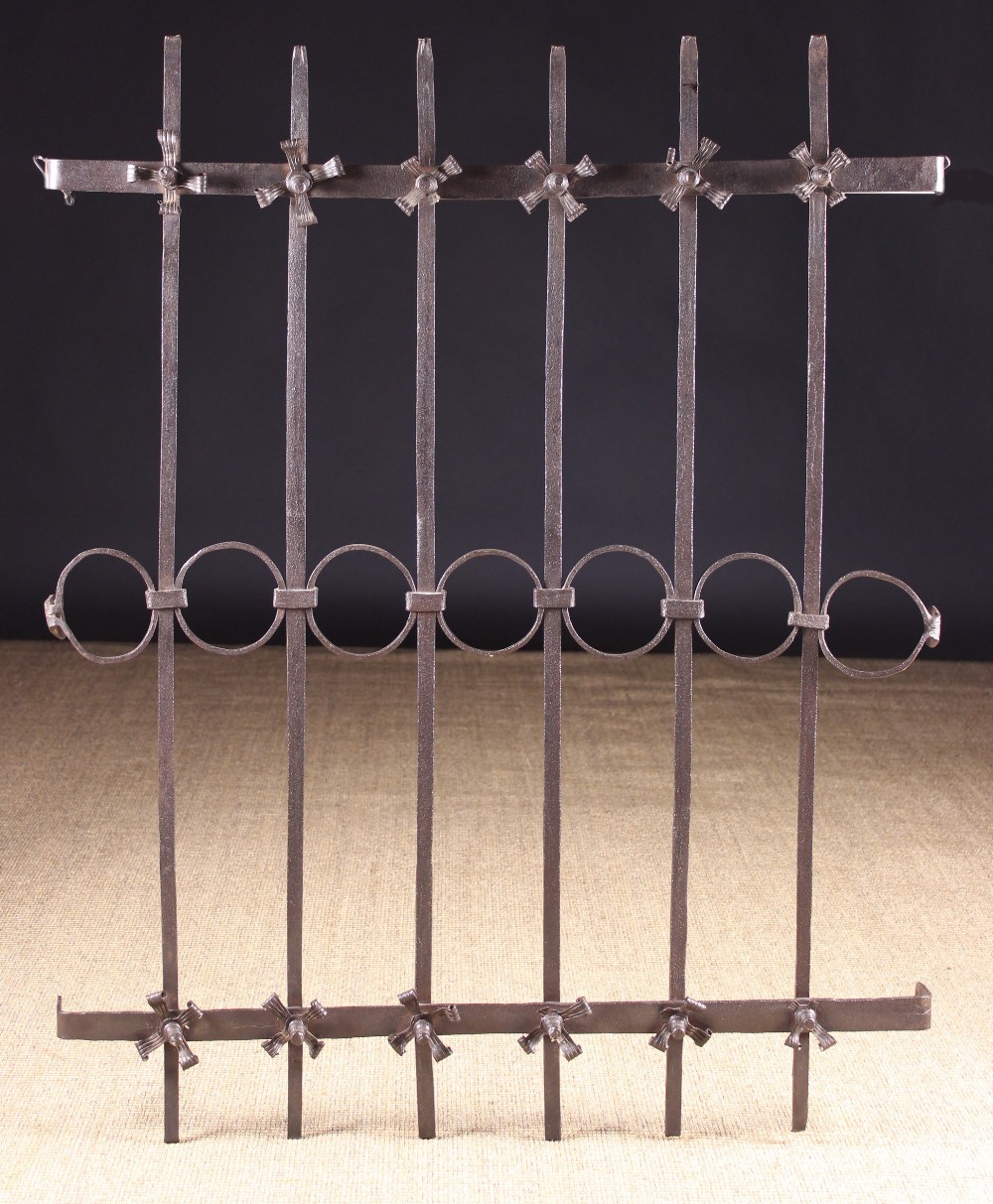 An Antique Wrought Iron Window Grill composed of seven vertical bars joined by a central row of