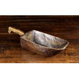 An 18th Century Dug-out Treen Grain Scoop with integral hook ended handle,