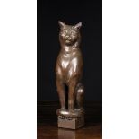 A Late 19th Century Wooden Finial carved in the form of a sitting cat, 16½ ins (41 cms) in height.