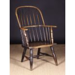 An Early 19th Century Stick Back Windsor Armchair with traces of residual paintwork,