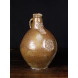 A 17th Century Saltglazed Stoneware Bellarmine Flagon with bearded face mask above an applied oval